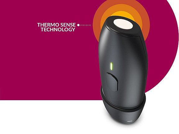 wie herpes vermeiden Ein schwarzes Gerät mit einer seitlichen Taste und einer grünen Kontrollleuchte mit der Aufschrift „THERMO SENSE TECHNOLOGY“ ist vor einem kastanienbraunen und weißen Hintergrund mit abgebildet.